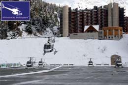 Helicopter taking off with the others waiting for their turn for the journey back to Geneva